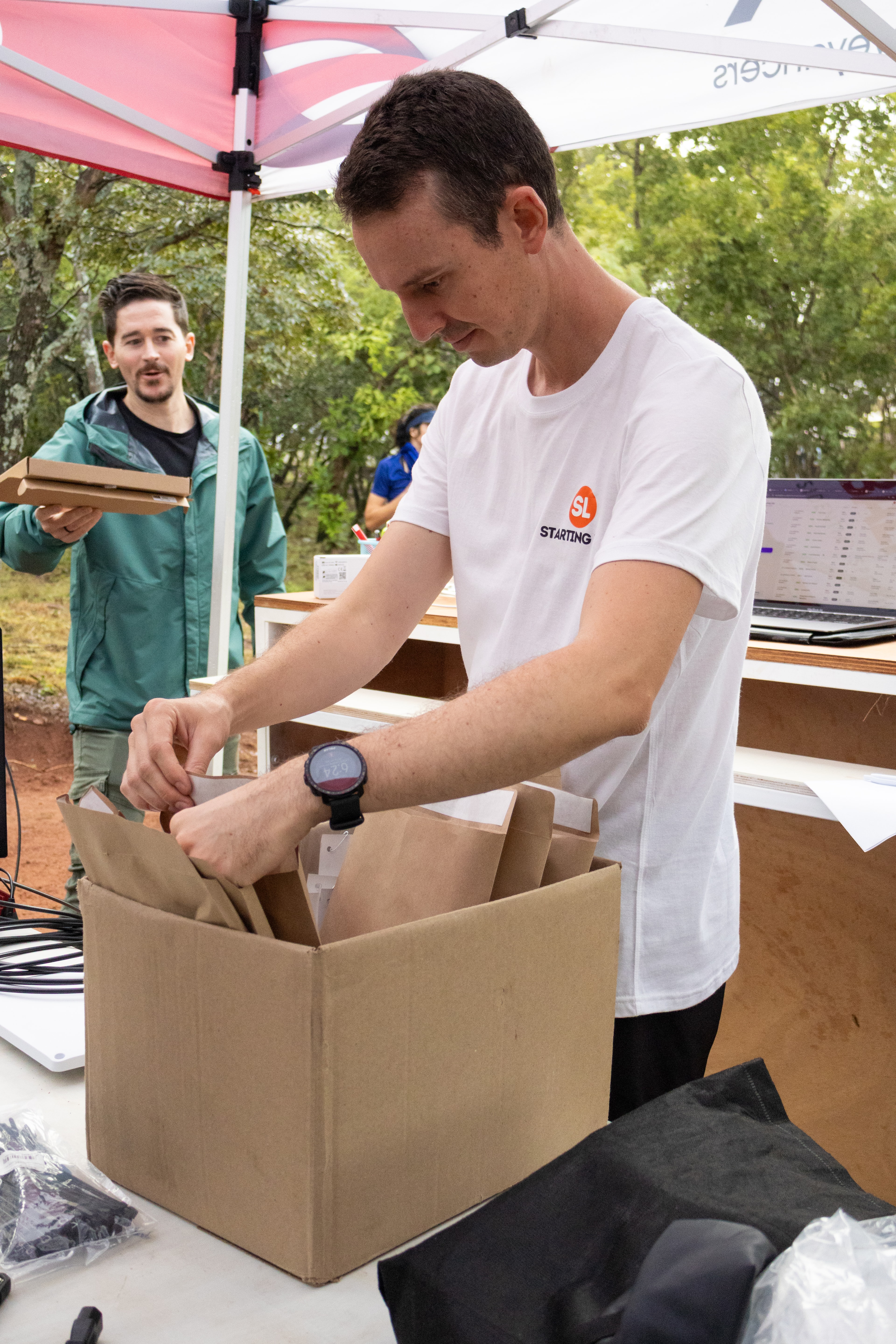 Starting Line team handling race packs at an event